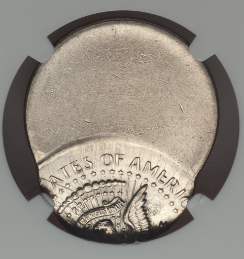 2023 Kennedy half dollar off-center strike error showing partial design and blank planchet area with visible date